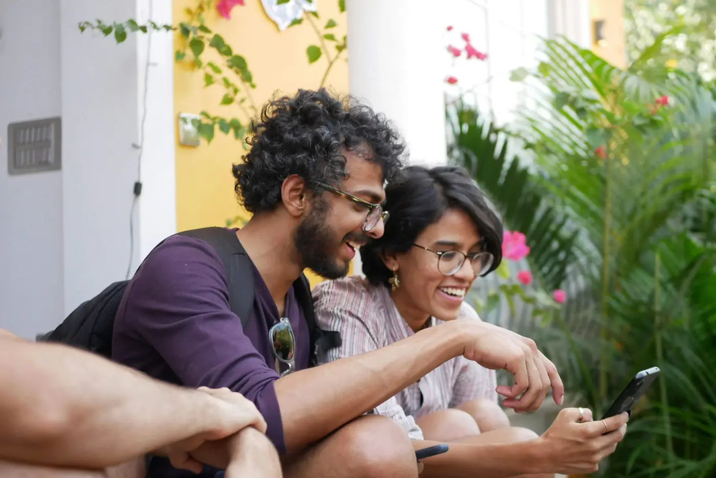 Two friends laughing at something on a phone